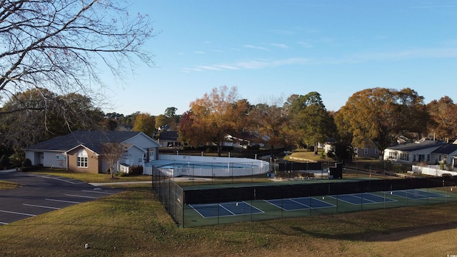 view of community featuring a pool and tennis court