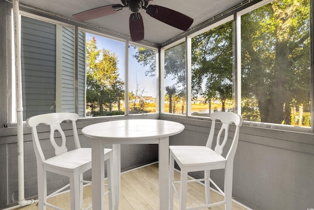 sunroom featuring ceiling fan