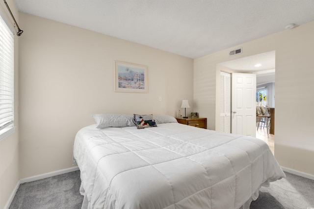 bedroom with carpet and a closet