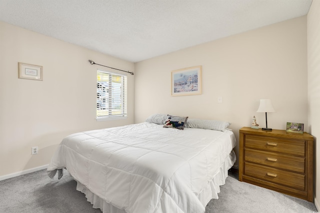 bedroom with carpet flooring and a textured ceiling