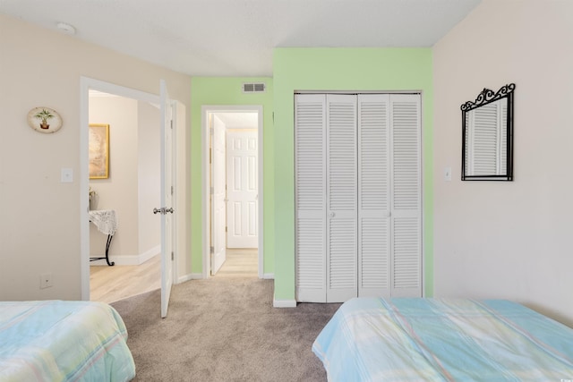 carpeted bedroom with a closet