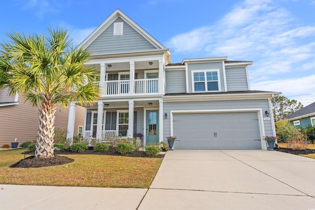 view of front of home with covered porch, a garage, and a front yard