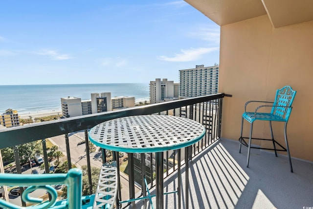 balcony with a water view and a beach view