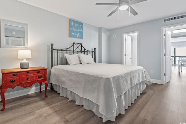 bedroom with light hardwood / wood-style floors and ceiling fan