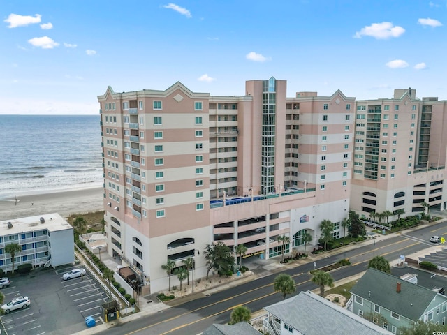 view of building exterior with a view of the beach and a water view