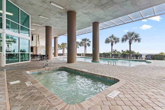 view of swimming pool with a community hot tub