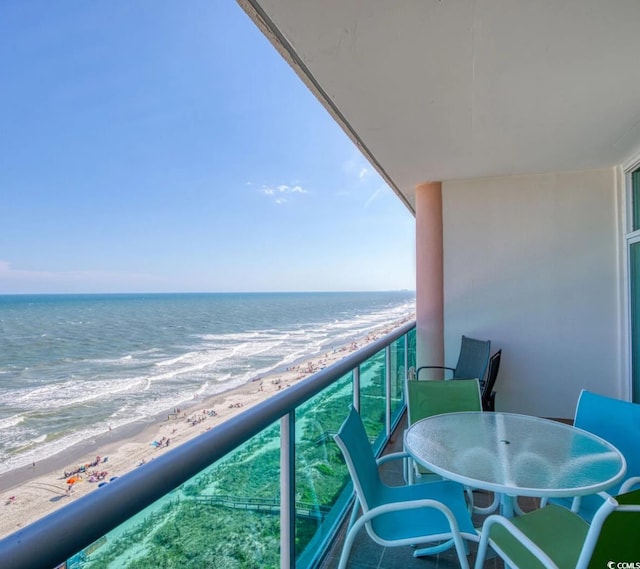 balcony with a water view and a beach view