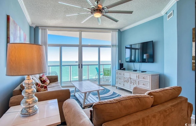 living room with floor to ceiling windows, ceiling fan, a textured ceiling, and ornamental molding