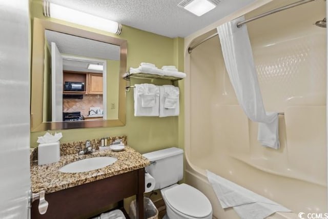 full bathroom featuring a textured ceiling, vanity, shower / bathtub combination, and toilet