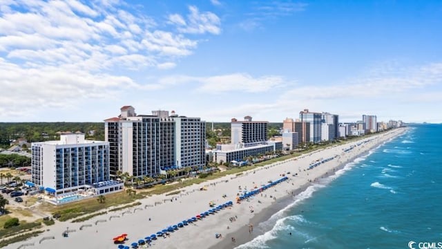 birds eye view of property with a beach view and a water view