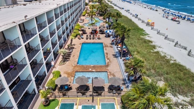 bird's eye view featuring a water view and a beach view