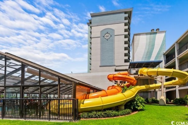 view of play area featuring a lanai and a yard