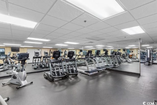 gym with a paneled ceiling