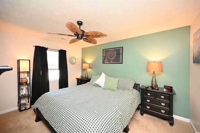 bedroom with ceiling fan and light colored carpet