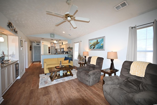 living room with wine cooler, lofted ceiling, a textured ceiling, dark hardwood / wood-style floors, and ceiling fan