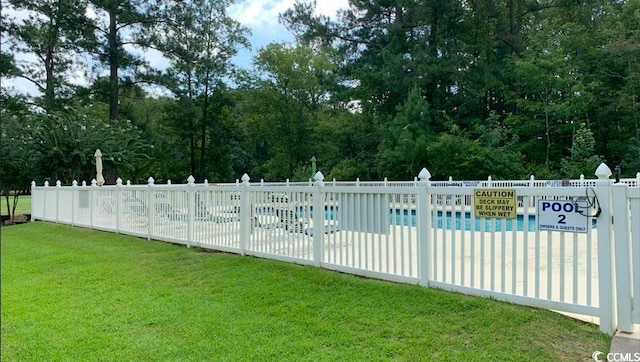 view of pool featuring a yard