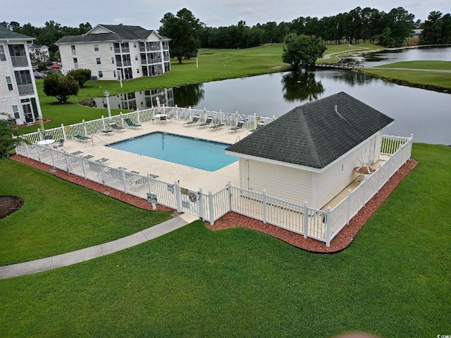 view of pool with a water view, a lawn, and a patio area