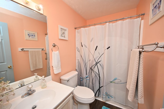 bathroom with toilet, wood-type flooring, a textured ceiling, vanity, and a shower with shower curtain