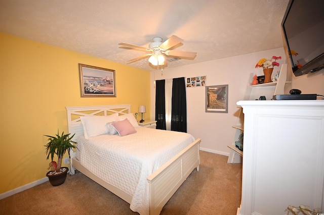 carpeted bedroom featuring a textured ceiling and ceiling fan