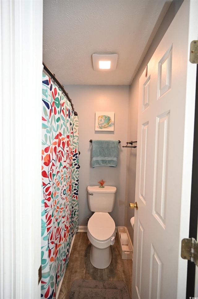 bathroom featuring a textured ceiling and toilet