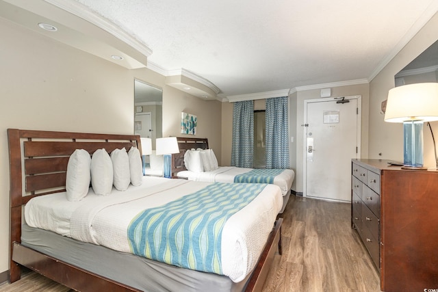 bedroom featuring wood-type flooring and ornamental molding