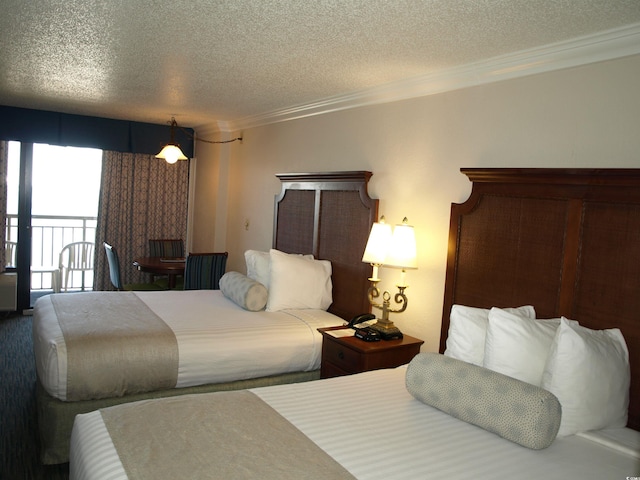 1200 N Ocean Blvd Unit 804, Myrtle Beach, SC 29577 - bedroom with a textured ceiling, ornamental molding, and access to outside