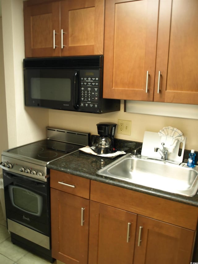1200 N Ocean Blvd Unit 804, Myrtle Beach, SC 29577 - kitchen with stainless steel electric range oven, black microwave, a sink, and brown cabinetry
