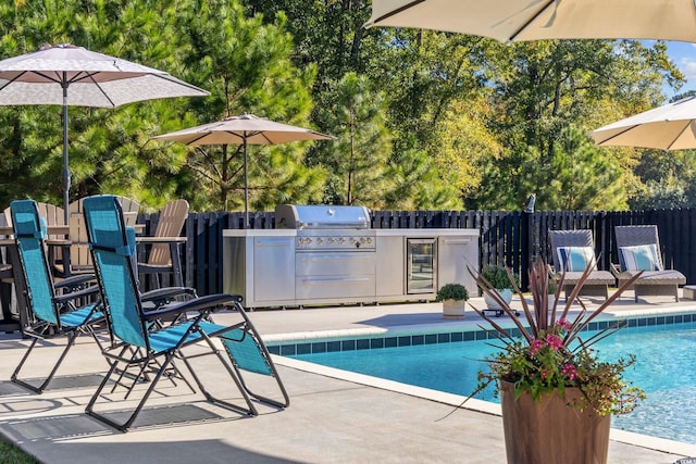 view of swimming pool with area for grilling, a patio, and grilling area