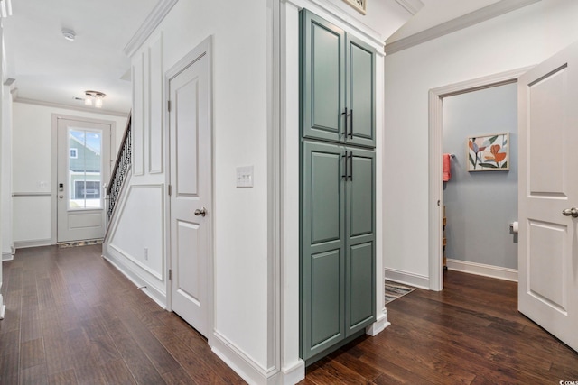 corridor with dark hardwood / wood-style floors and crown molding