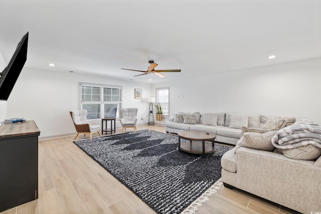 living room with ceiling fan and light hardwood / wood-style floors