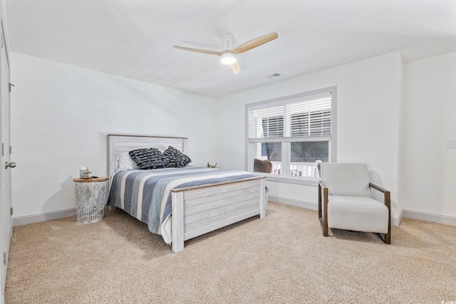 bedroom featuring ceiling fan and light carpet