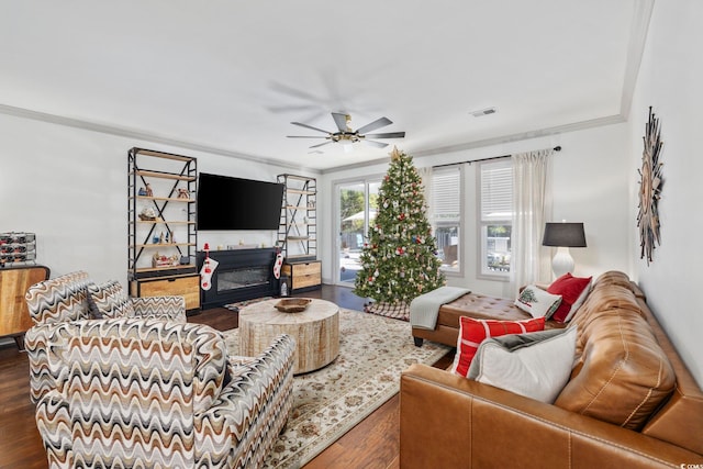 living room with ceiling fan, dark hardwood / wood-style flooring, a fireplace, and crown molding