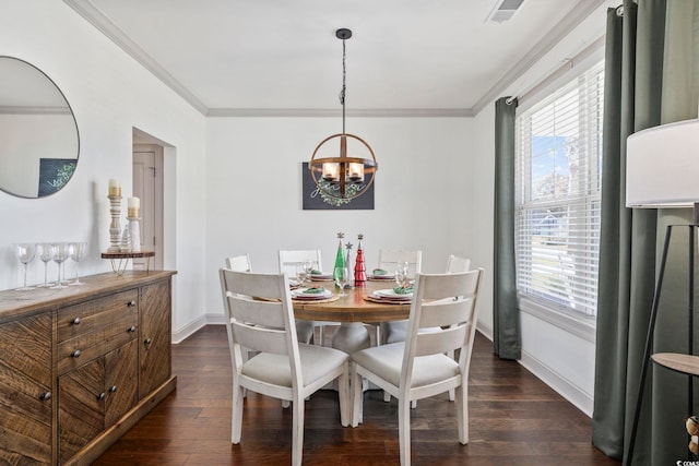 dining room featuring dark wood-type flooring, a healthy amount of sunlight, and an inviting chandelier