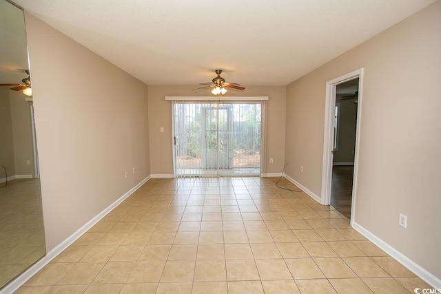 tiled spare room with ceiling fan