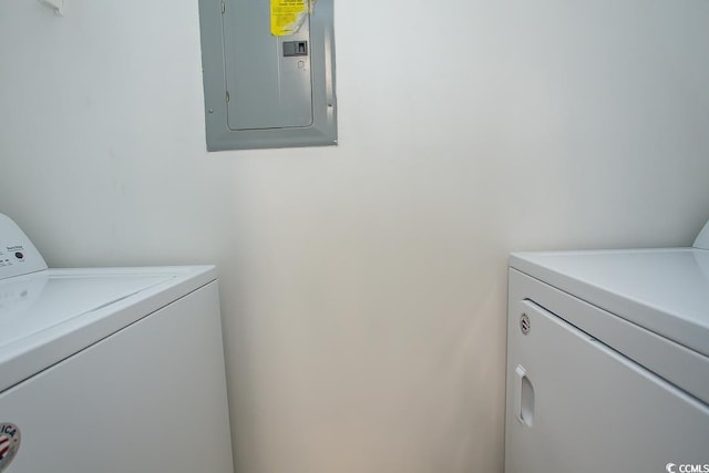 clothes washing area featuring independent washer and dryer and electric panel