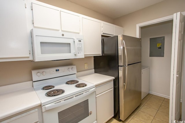 kitchen with white cabinets, light tile patterned flooring, white appliances, and electric panel