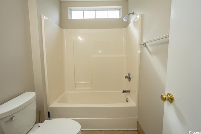 bathroom featuring bathtub / shower combination, tile patterned floors, and toilet