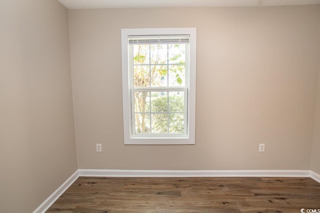 spare room with dark wood-type flooring