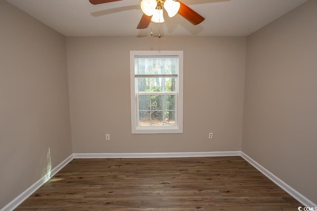 unfurnished room with ceiling fan and dark wood-type flooring