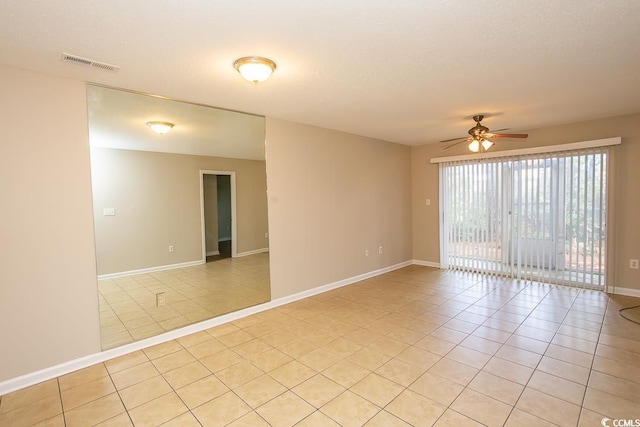 unfurnished room featuring ceiling fan and light tile patterned flooring