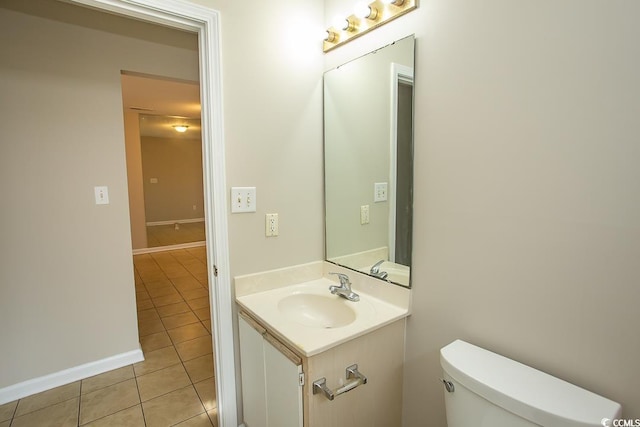 bathroom featuring toilet, sink, and tile patterned flooring