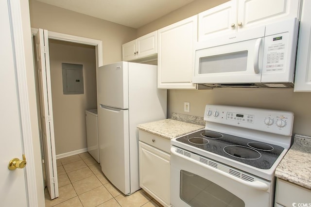 kitchen with light tile patterned flooring, electric panel, white appliances, washer / dryer, and white cabinets