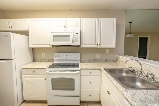 kitchen featuring white cabinetry, sink, and white appliances