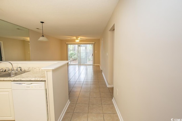 hallway featuring sink and light tile patterned floors