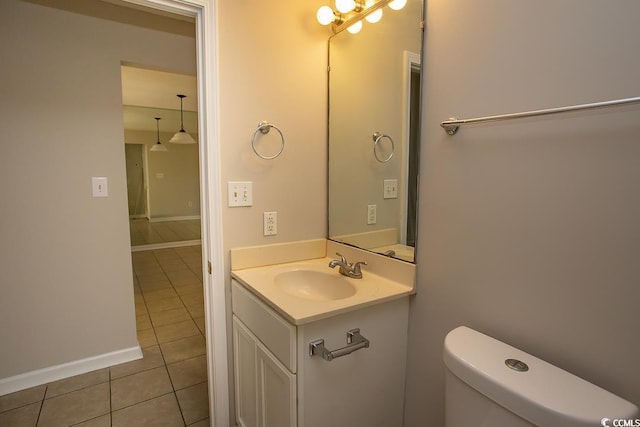 bathroom featuring tile patterned flooring, vanity, and toilet