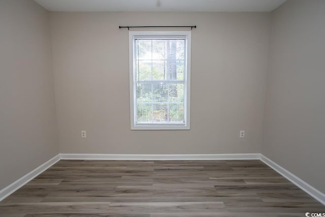 unfurnished room with hardwood / wood-style flooring