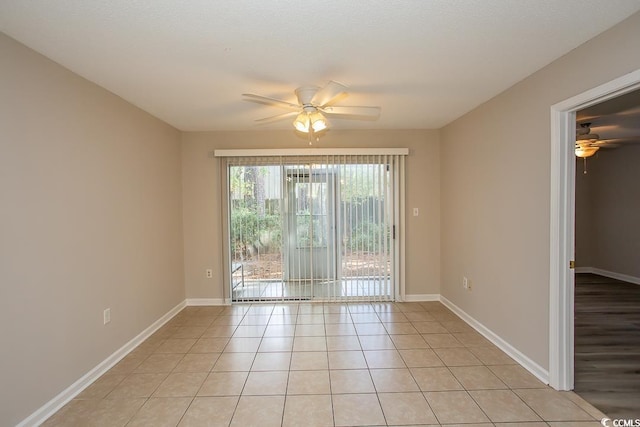 tiled empty room featuring ceiling fan