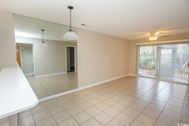 unfurnished room featuring ceiling fan and light tile patterned floors