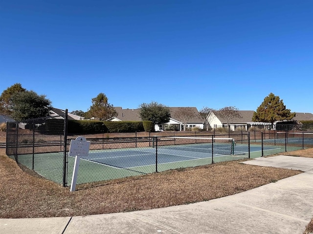 view of tennis court featuring fence