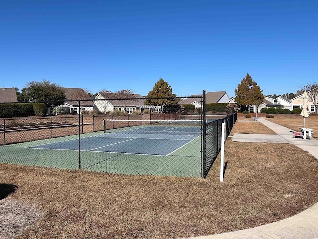 view of sport court featuring a residential view and fence